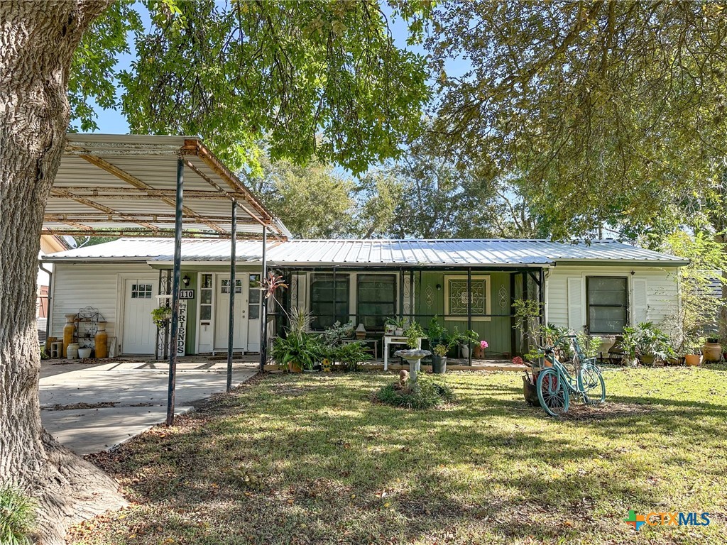 a backyard of a house with yard table and chairs