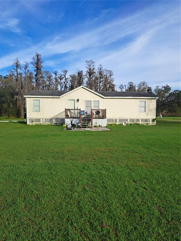 a view of a house with a yard and sitting area