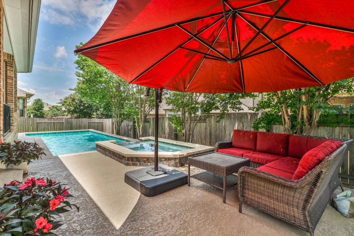 a view of yard with patio and umbrella