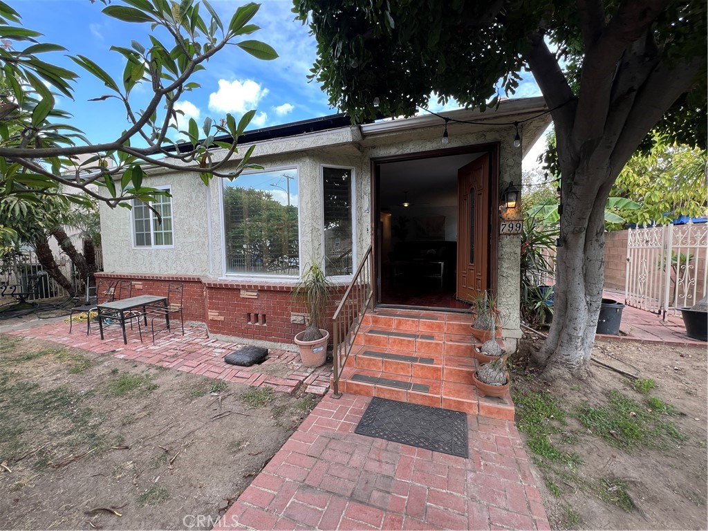 a front view of a house with outdoor seating