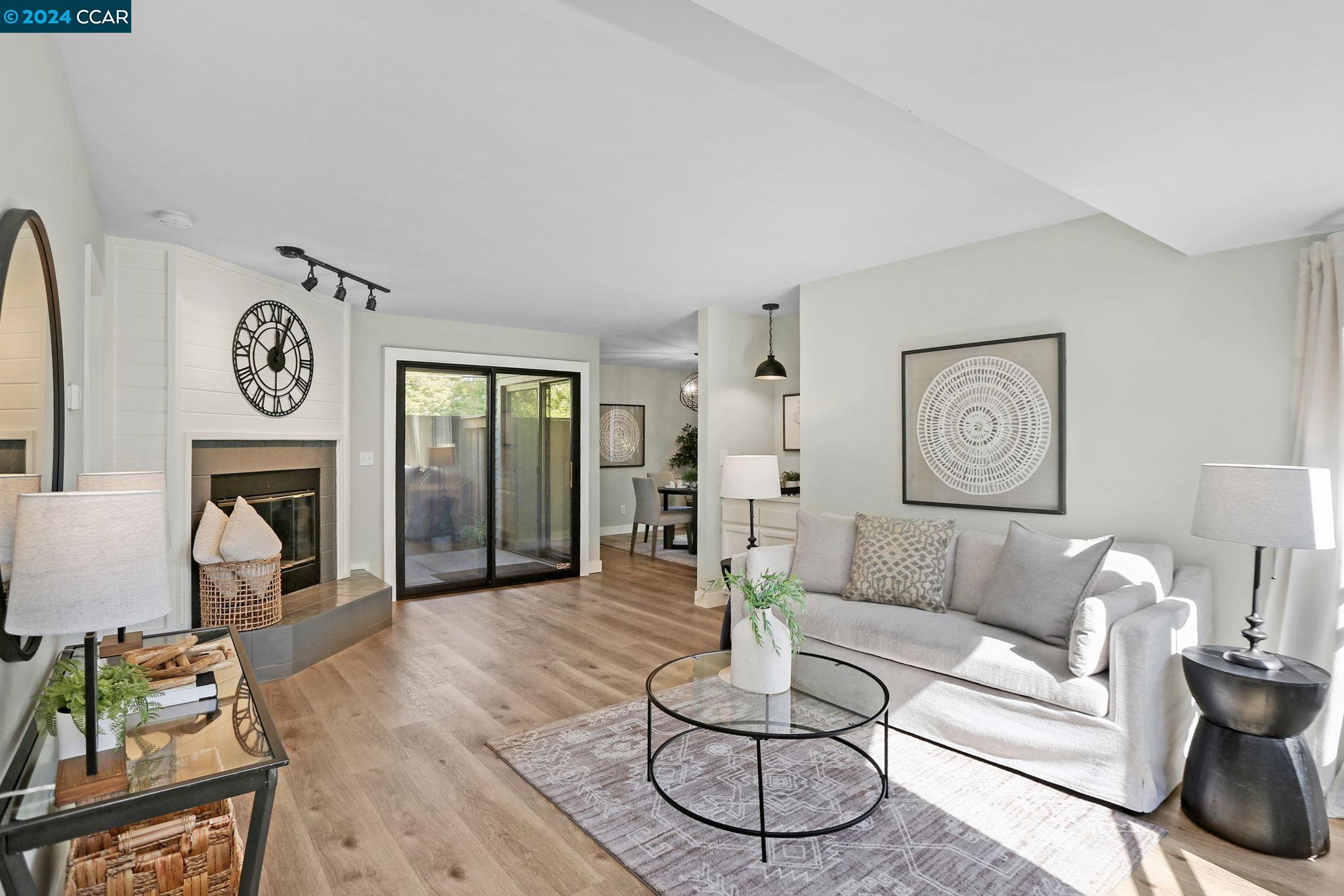 a living room with furniture a rug and a fireplace