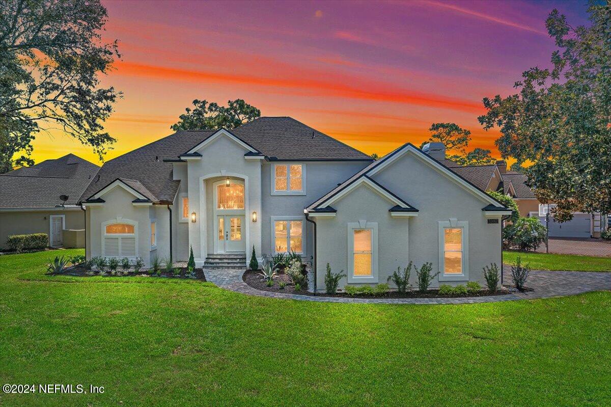 a front view of house with yard and green space