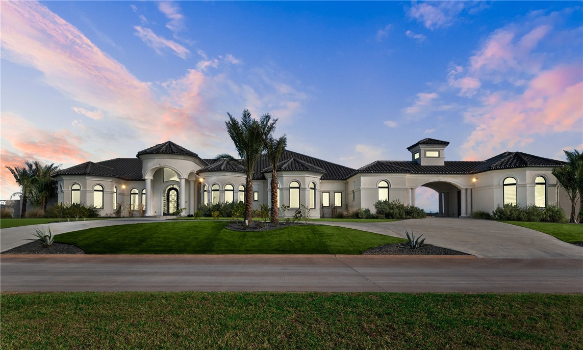 a front view of a house with a yard and a garage