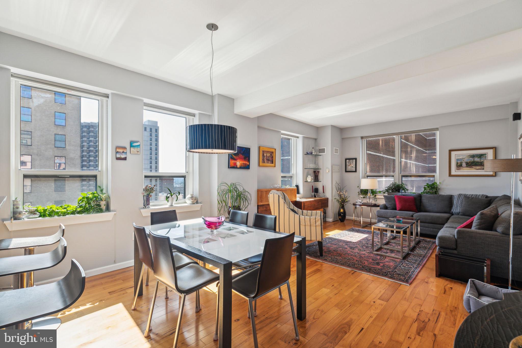 a living room with furniture a dining table and a window