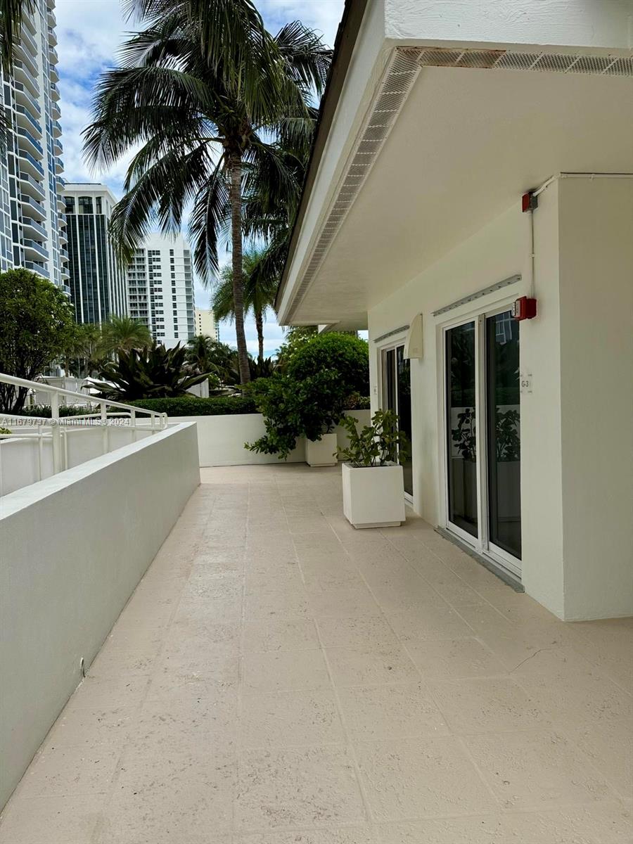 a view of a house with outdoor space and palm trees