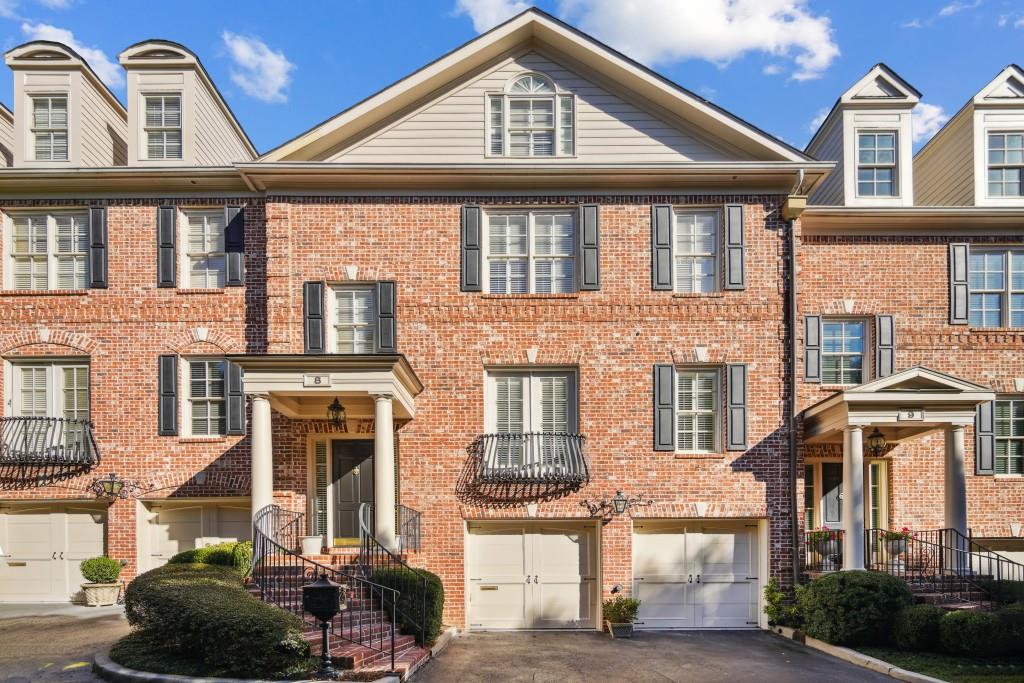 a front view of a residential apartment building with a yard