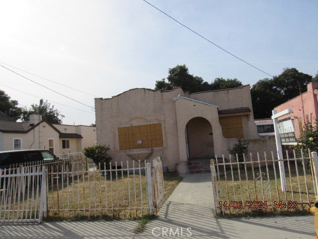 a view of a brick house with many windows next to a road