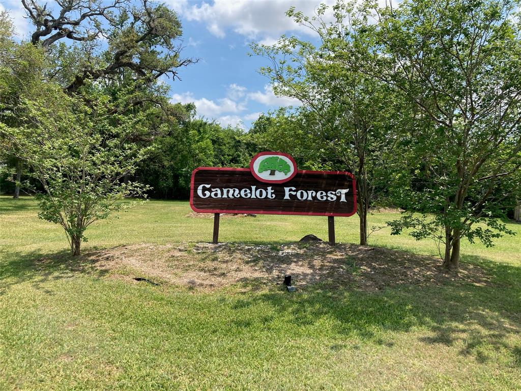 a sign board with a tree in the background