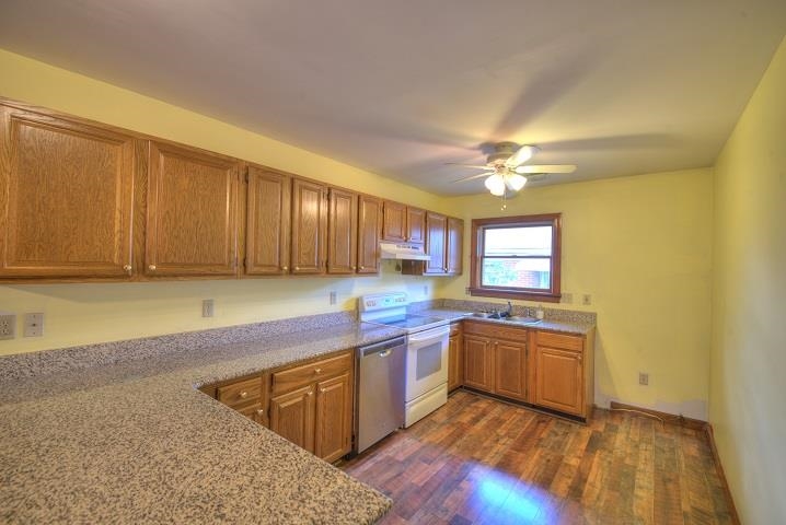 a kitchen with a sink cabinets and window