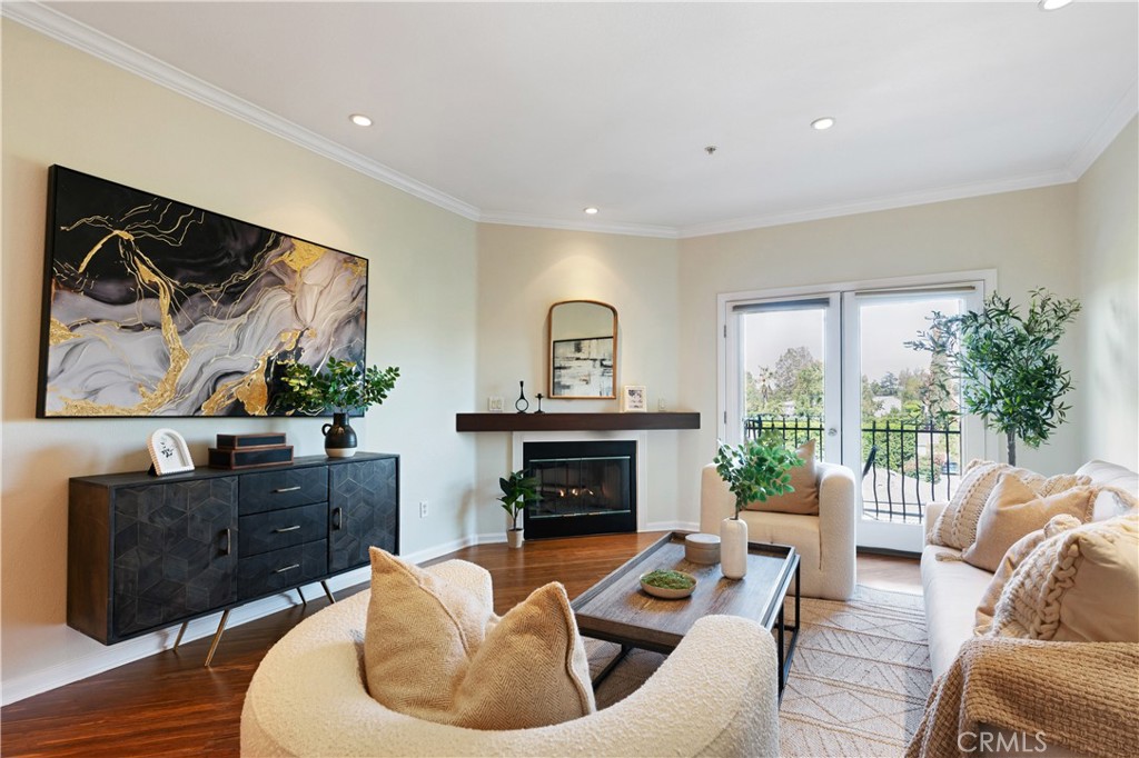 a living room with furniture a fireplace and a floor to ceiling window