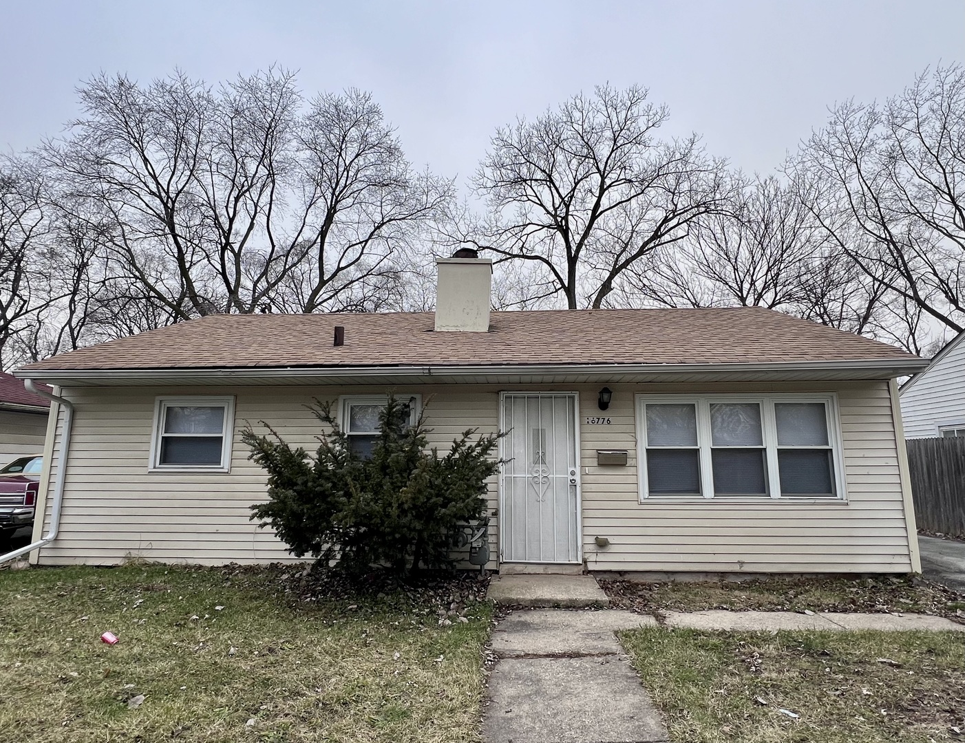 a house that has a tree in front of the house