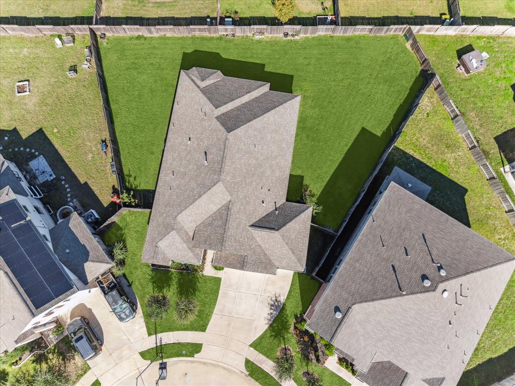 an aerial view of a house with a yard