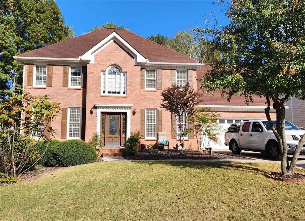 a front view of a house with swimming pool and porch