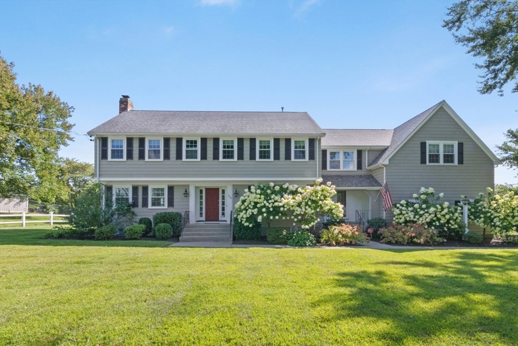 a front view of a house with garden