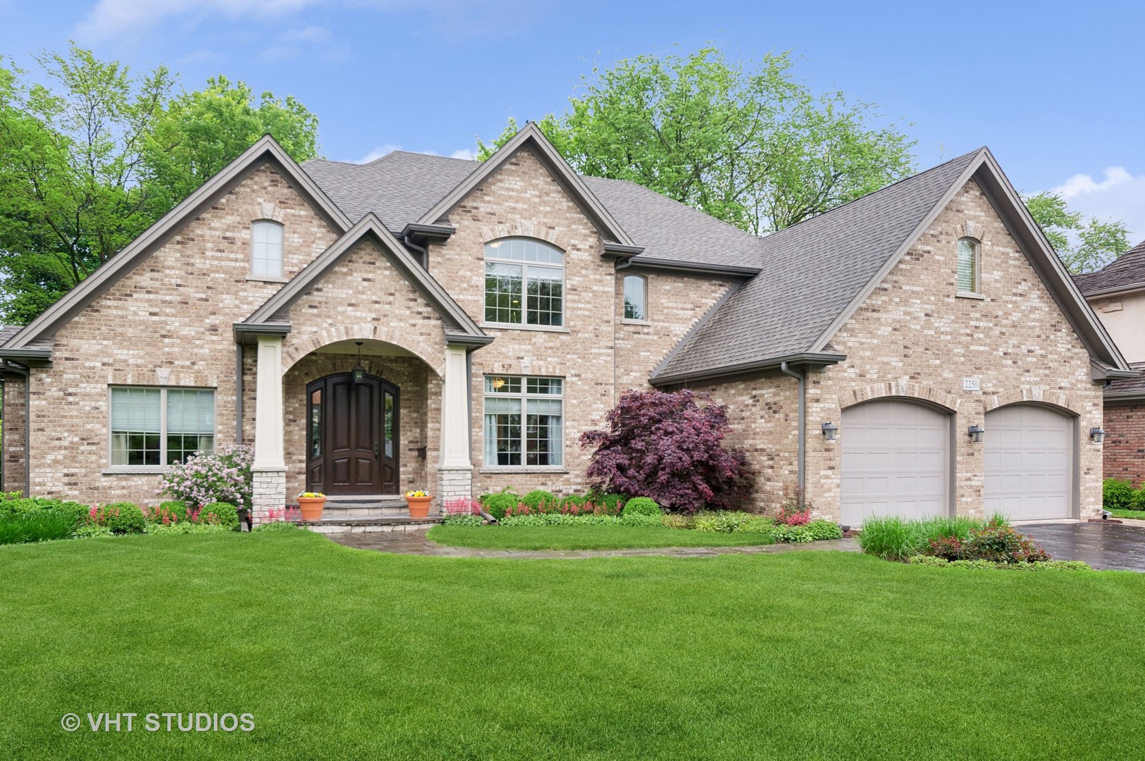 a front view of a house with garden