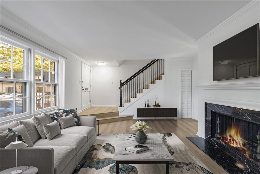 a living room with furniture a fireplace and a flat screen tv