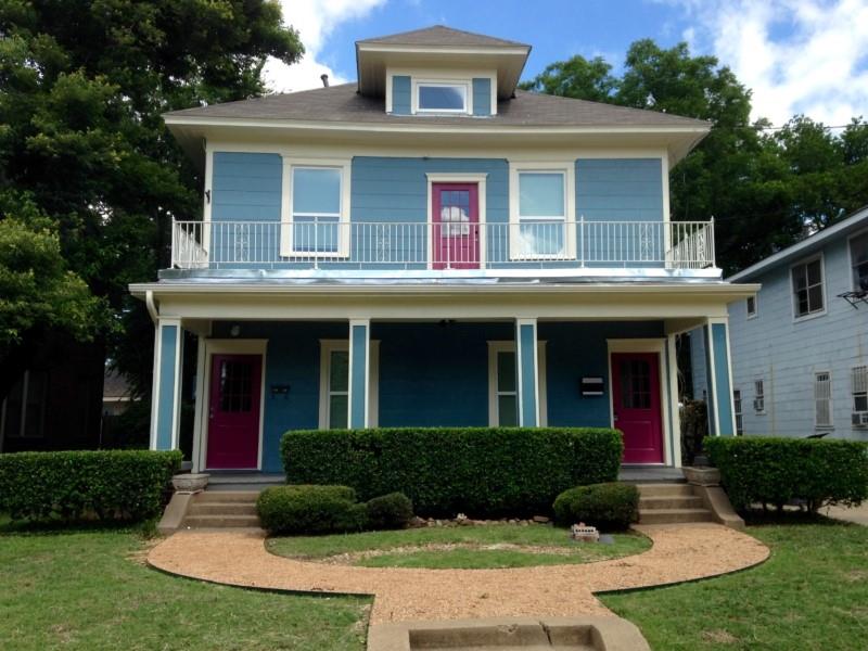 a front view of a house with yard and green space