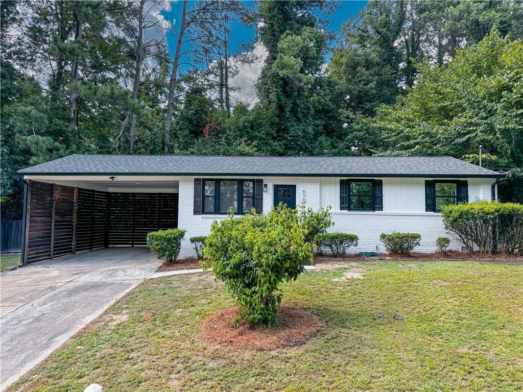 a front view of house with a garden and patio