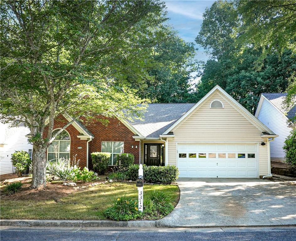 a view of a house next to a yard with big trees