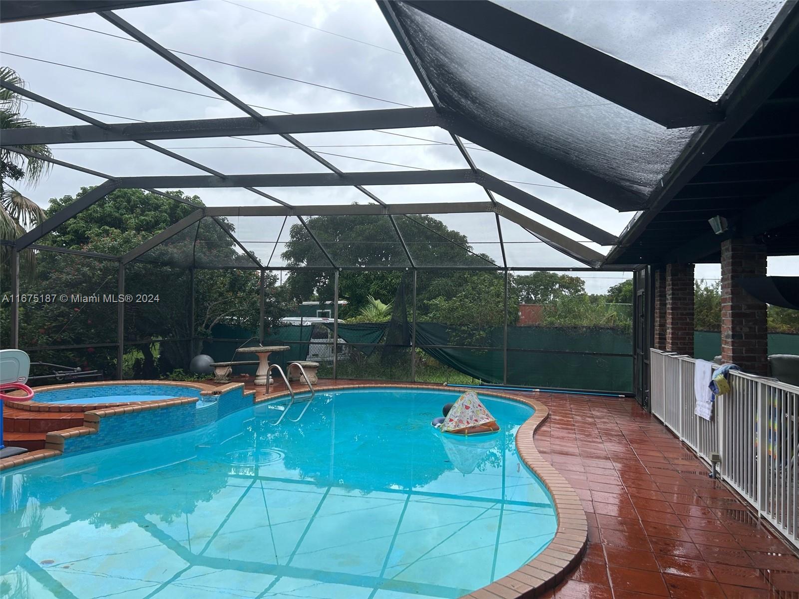 a view of a swimming pool with a patio