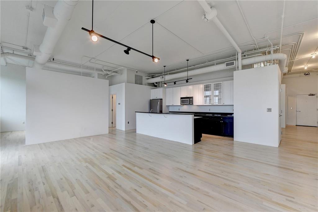 a view of a kitchen with a sink and a refrigerator