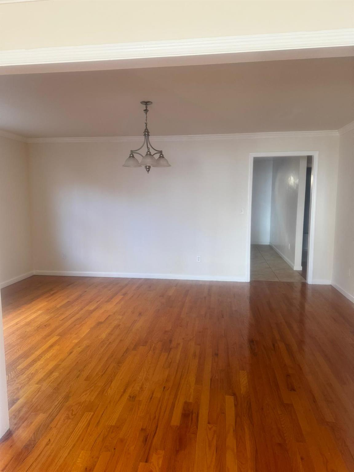 a view of an empty room and wooden floor