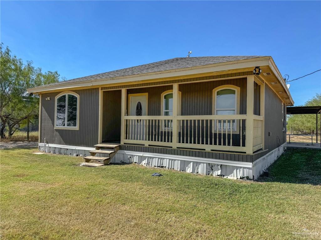 View of front facade with a front lawn and a porch