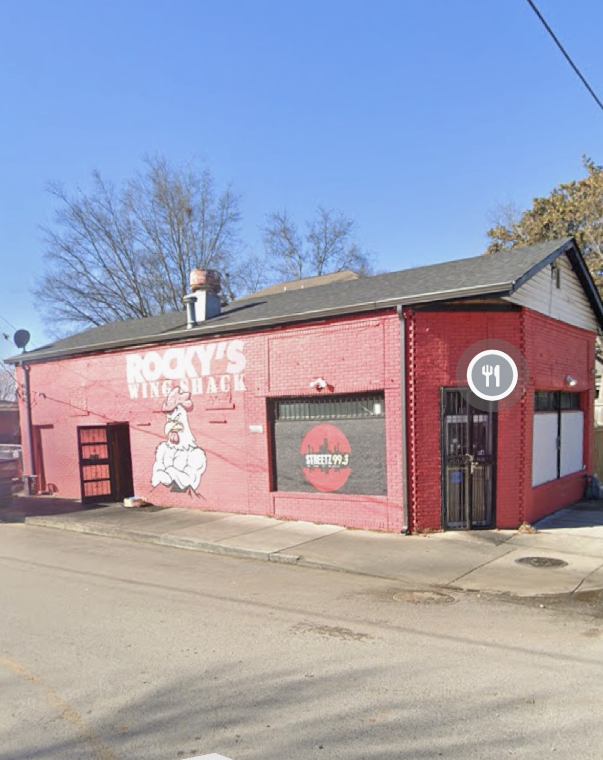 a front view of a building with sign board