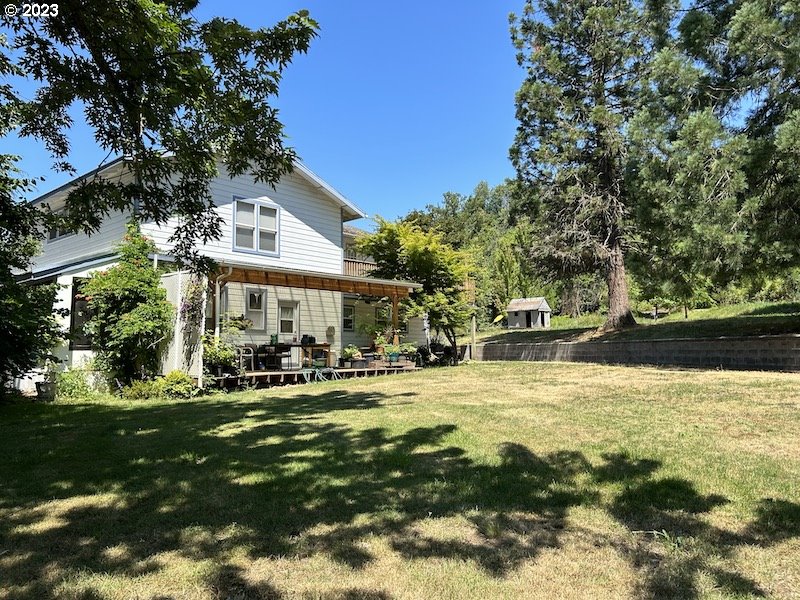 a view of a house with swimming pool and sitting area