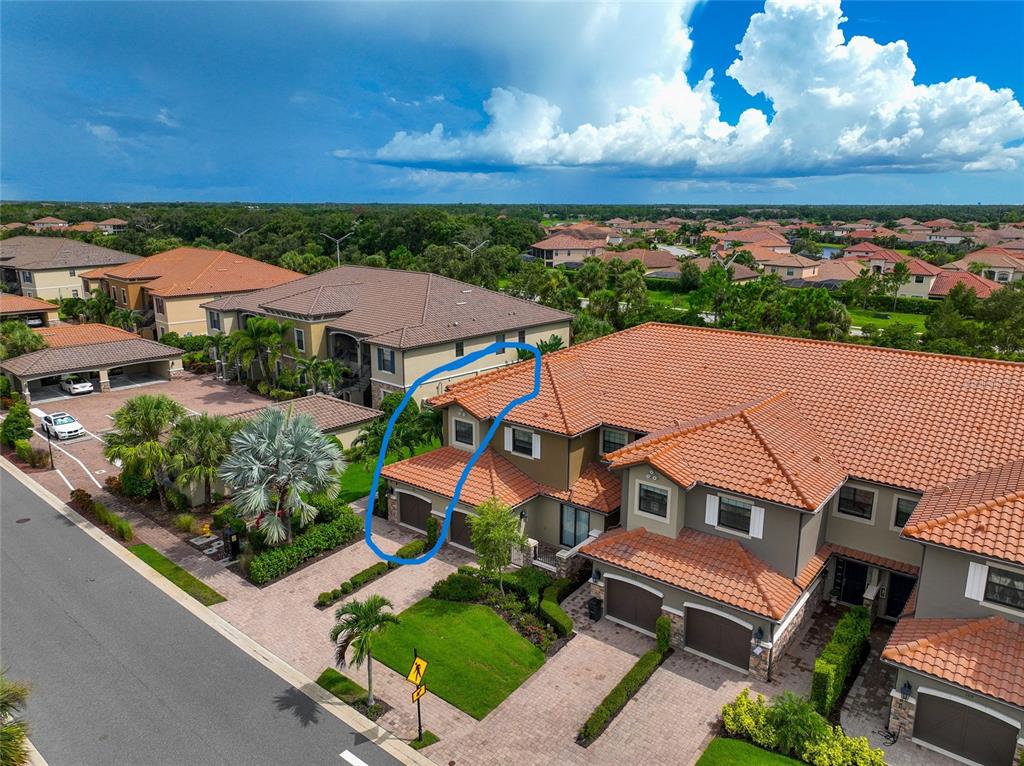 an aerial view of multiple houses with a yard