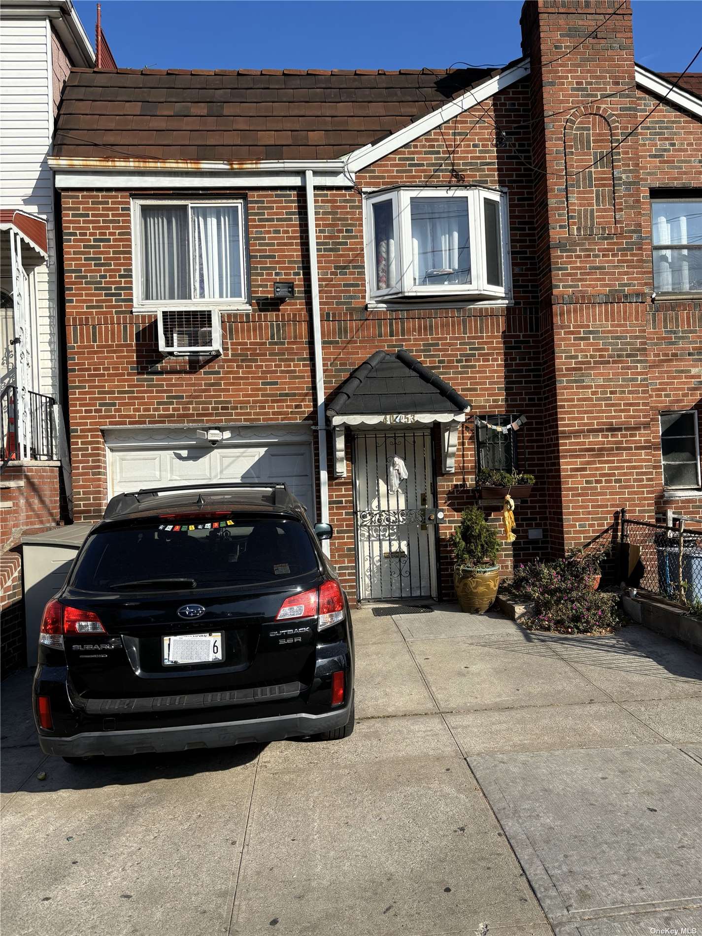 a car parked in front of a brick house