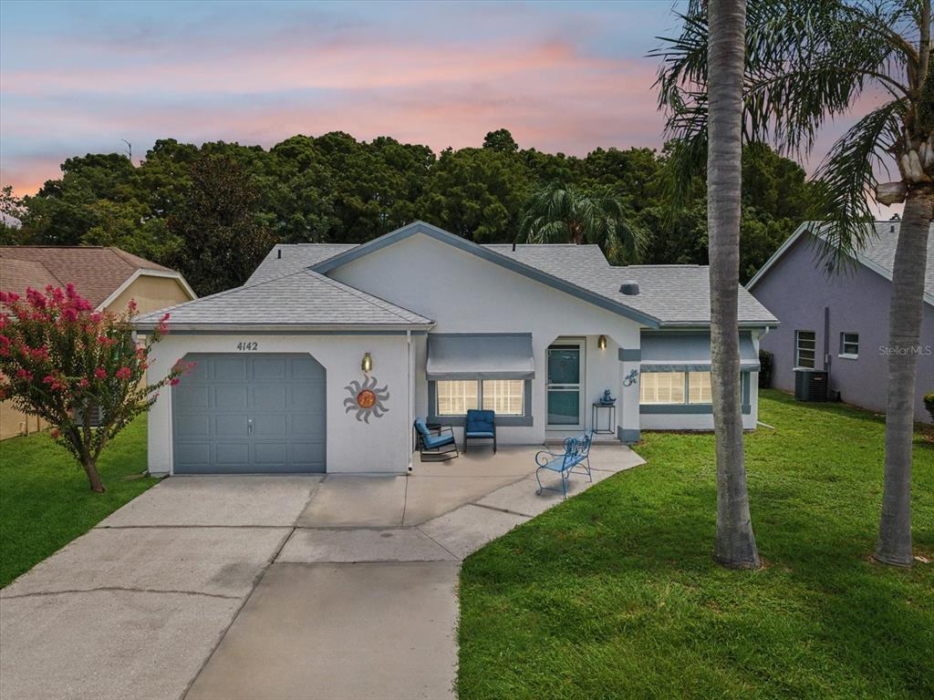 a view of a house with a yard and pathway