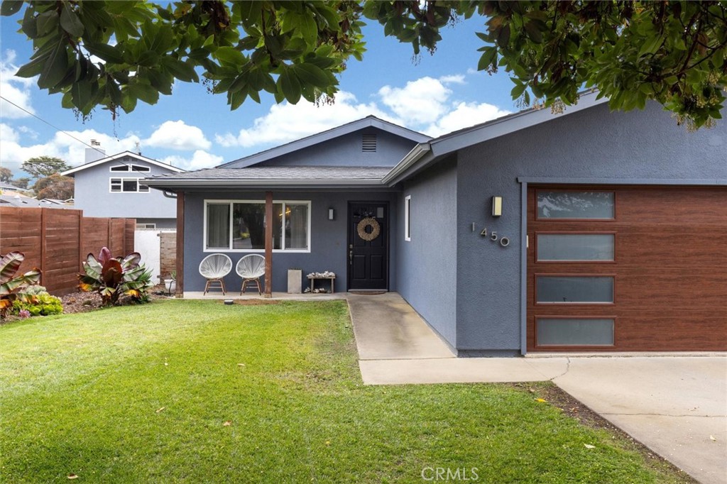 a view of a house with a yard and garage