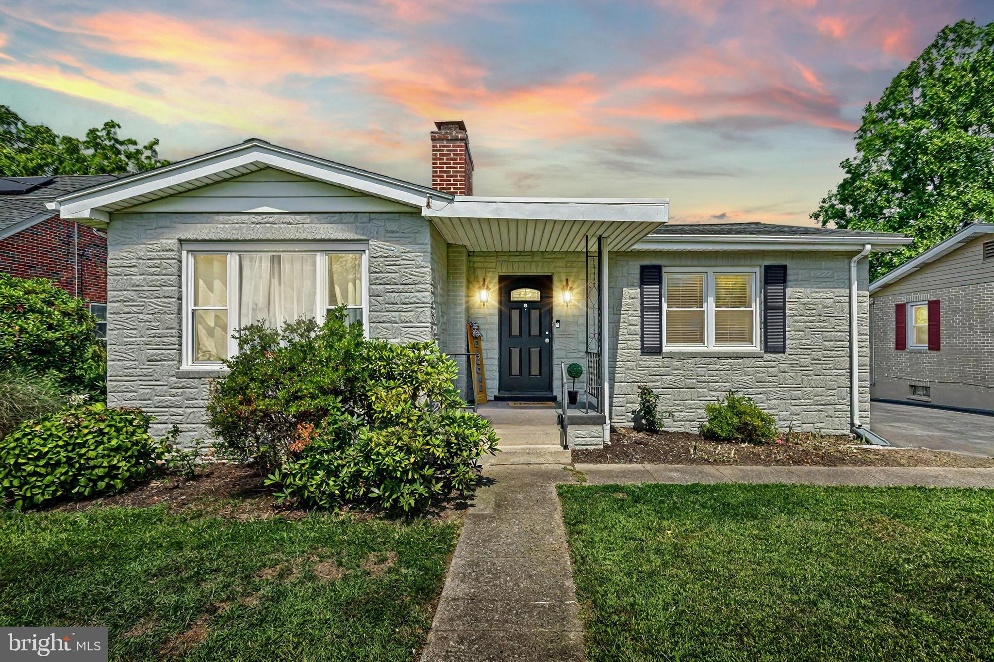 a front view of a house with a garden