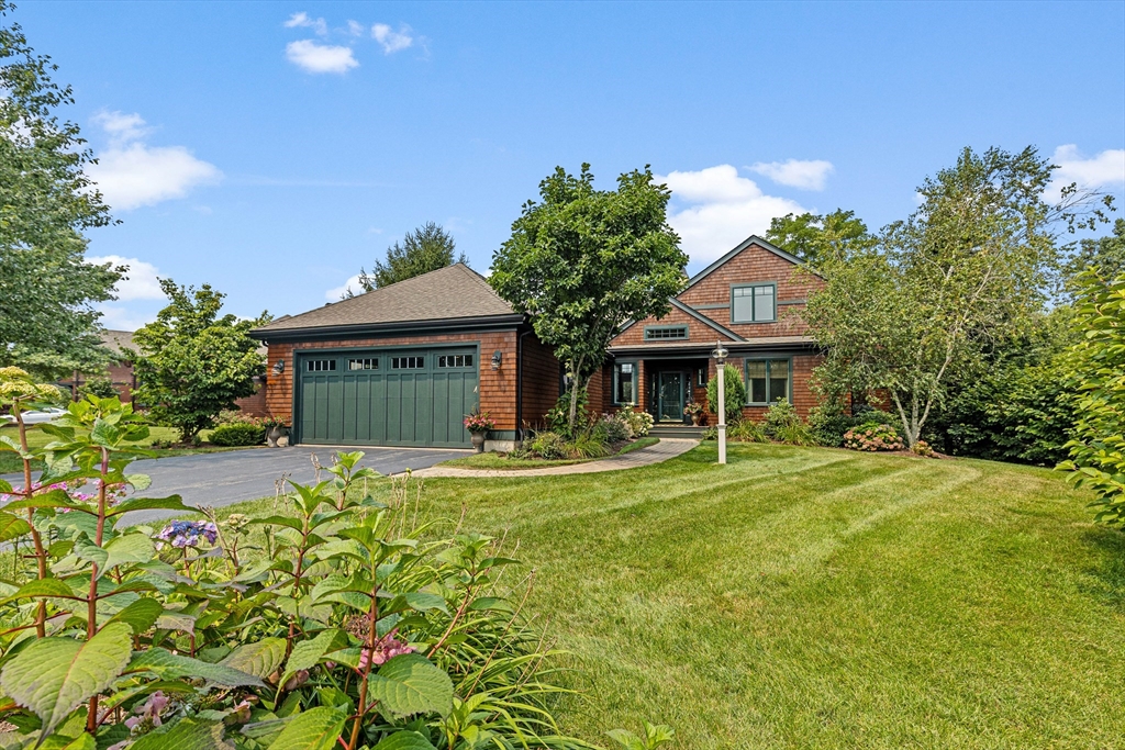 a front view of a house with a garden