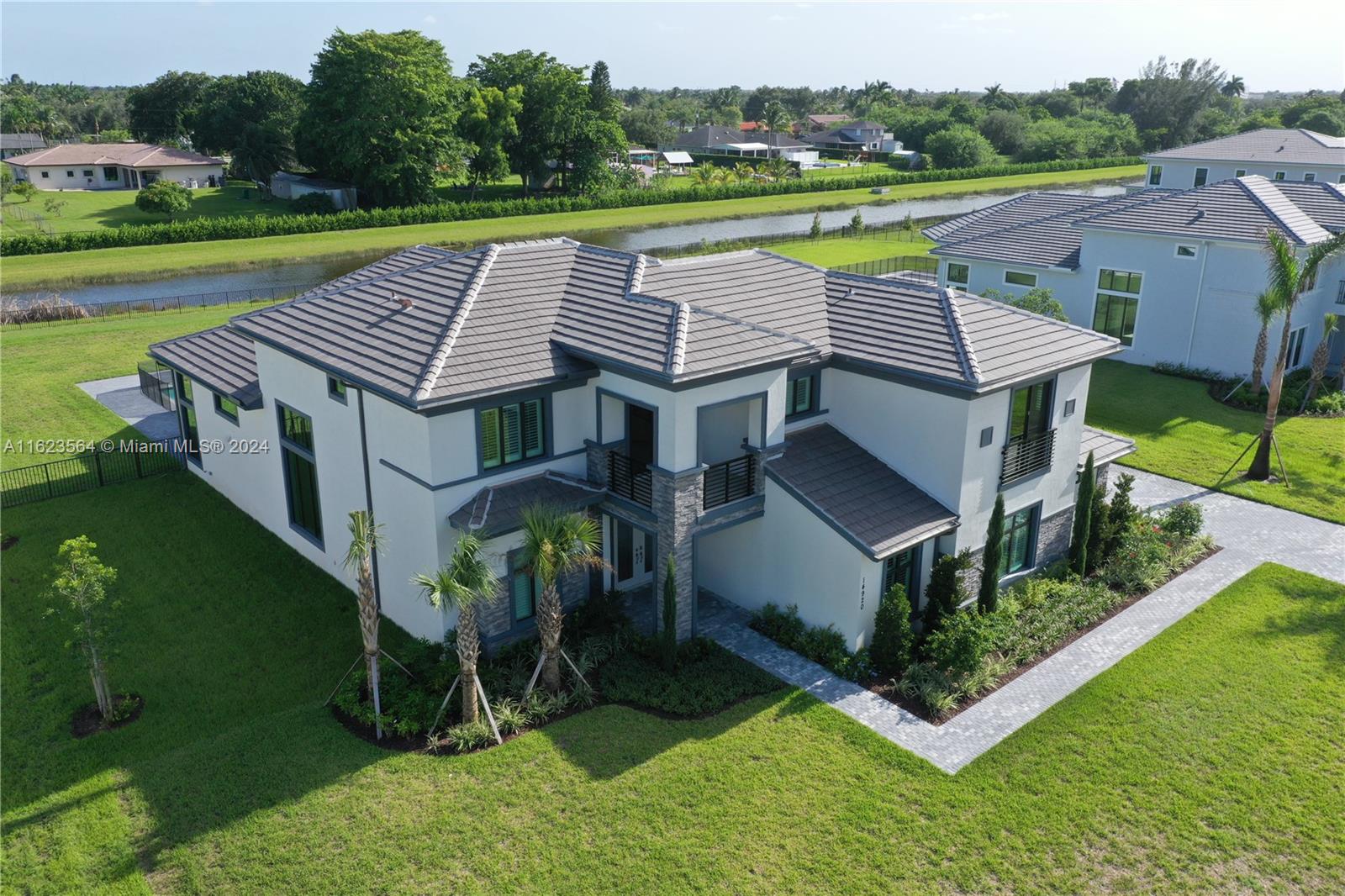 an aerial view of a house with garden space and street view