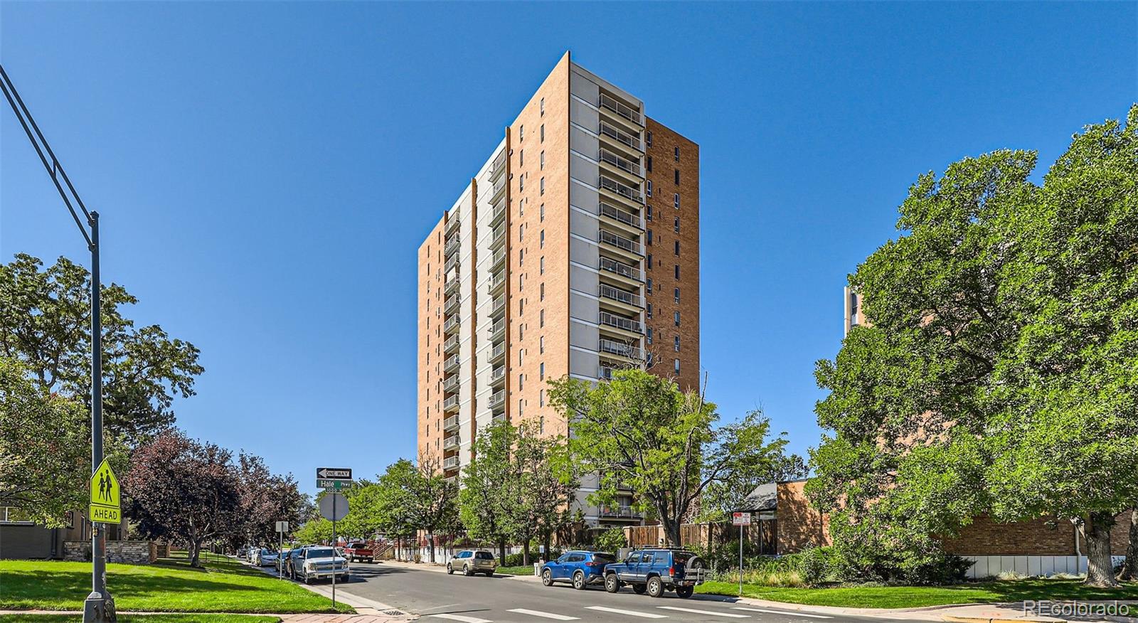 a view of a tall building next to a road