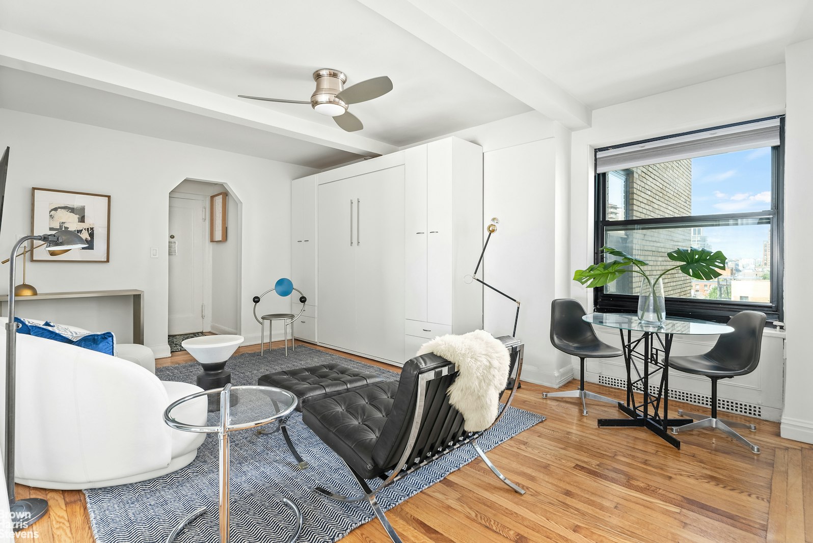 a living room with furniture a window and a table