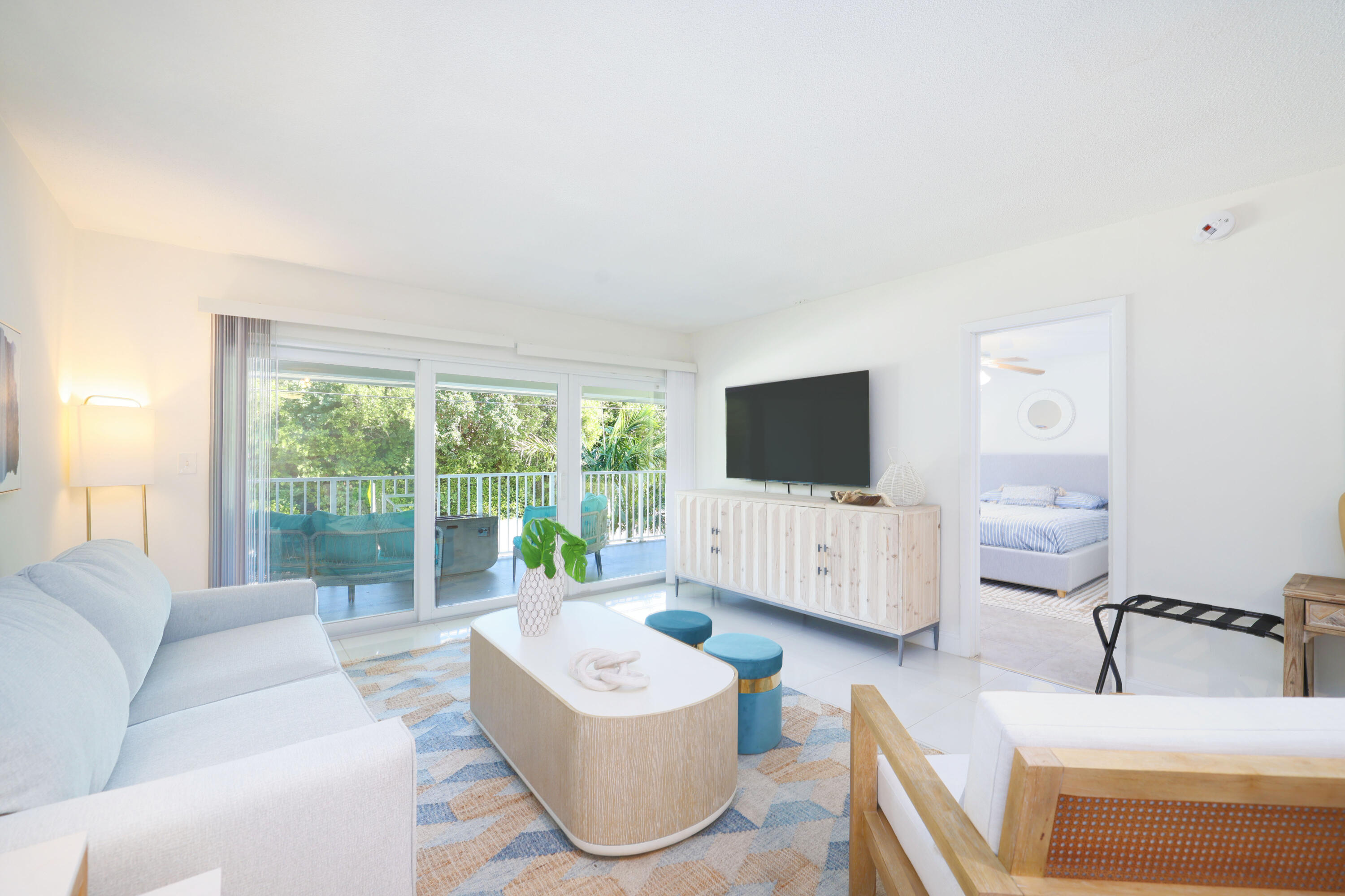 a living room with furniture a large window and a flat screen tv