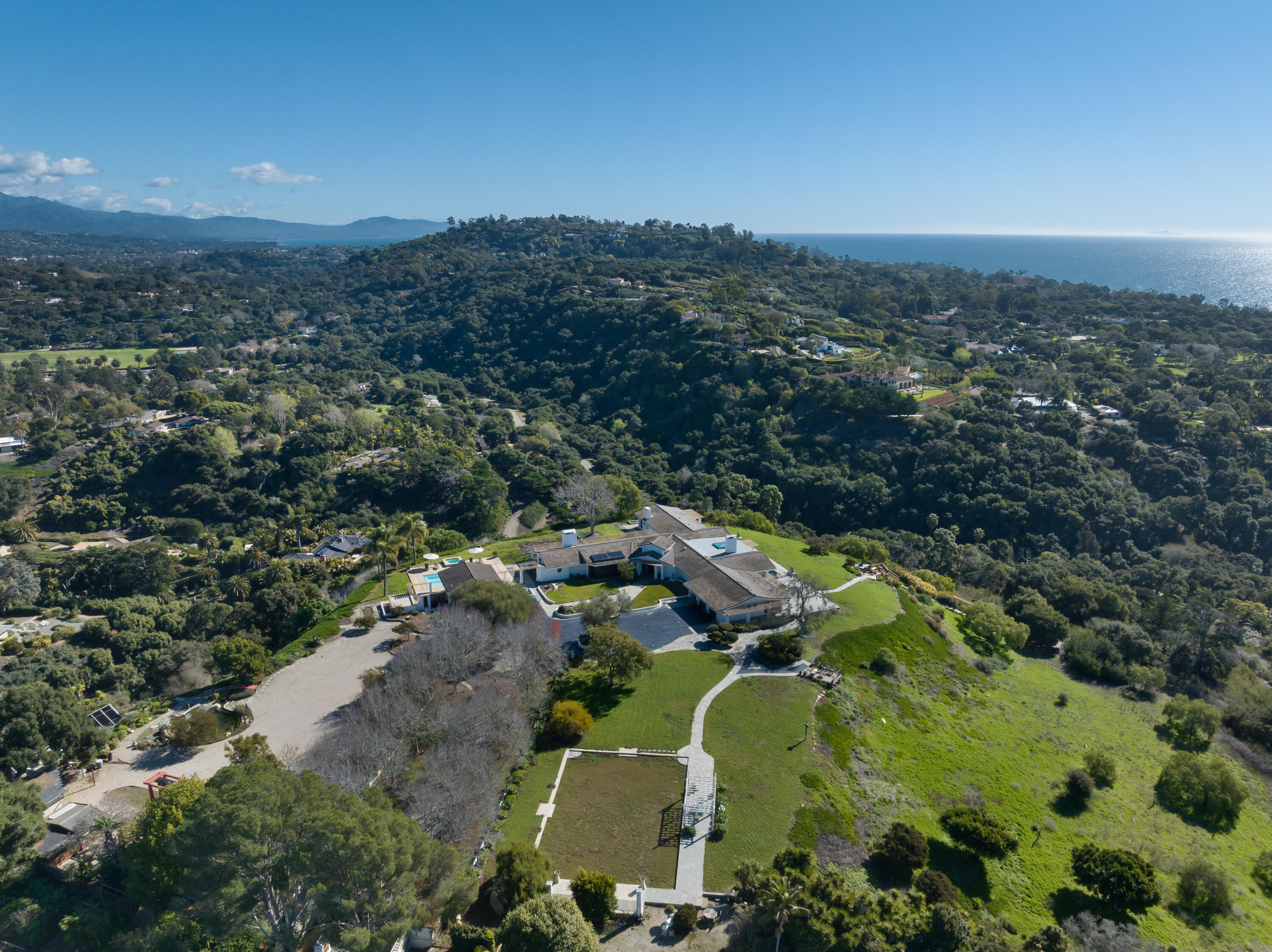 an aerial view of a houses with a yard