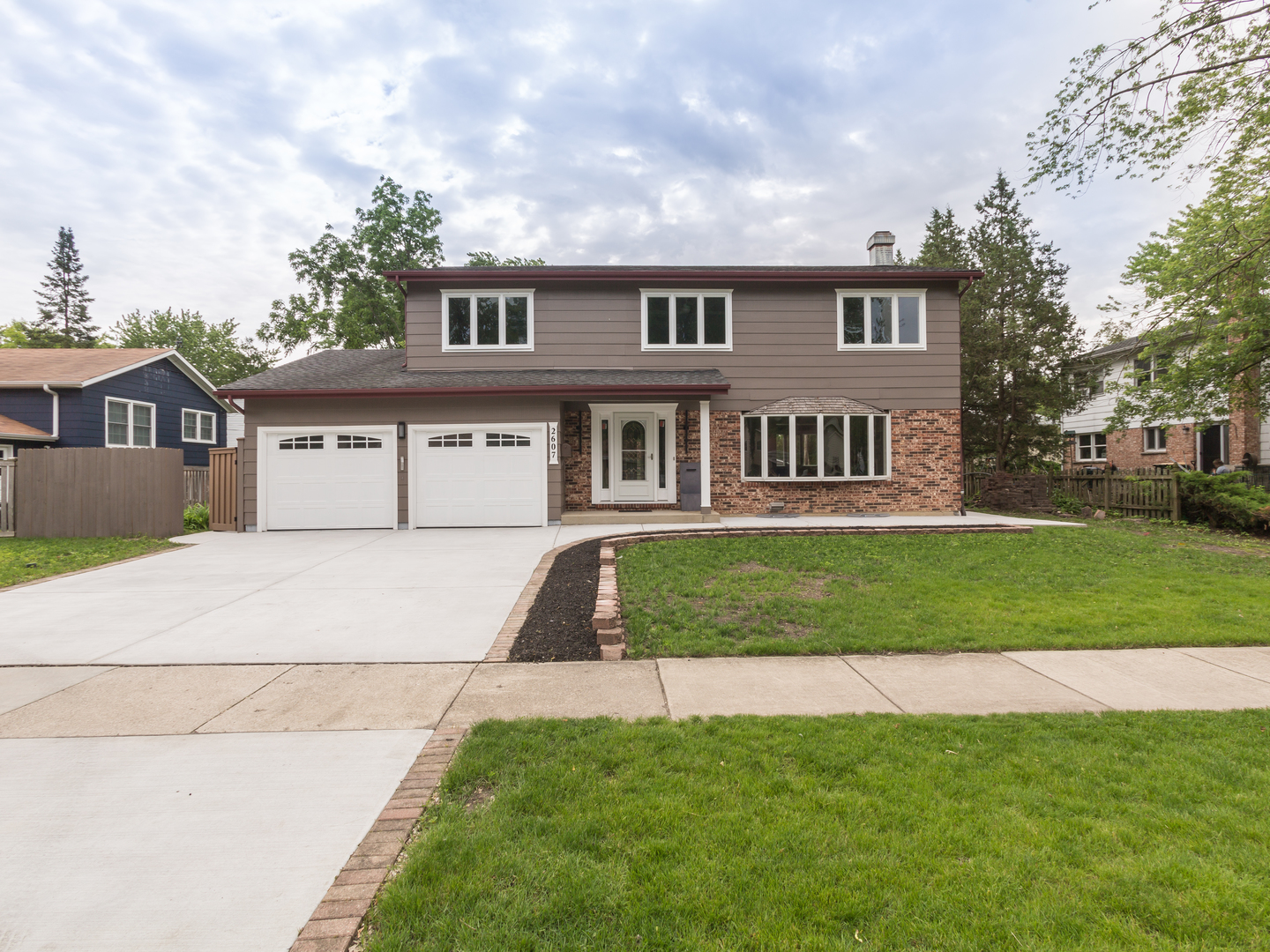 a front view of a house with a garden