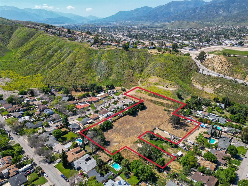 an aerial view of residential houses with outdoor space and swimming pool