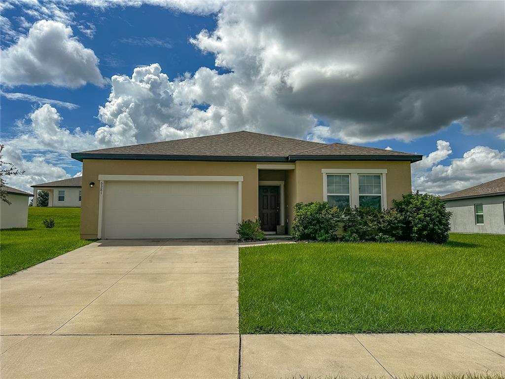 a front view of house with yard and entertaining space