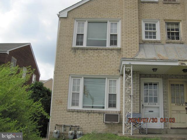 front view of a brick house with a window