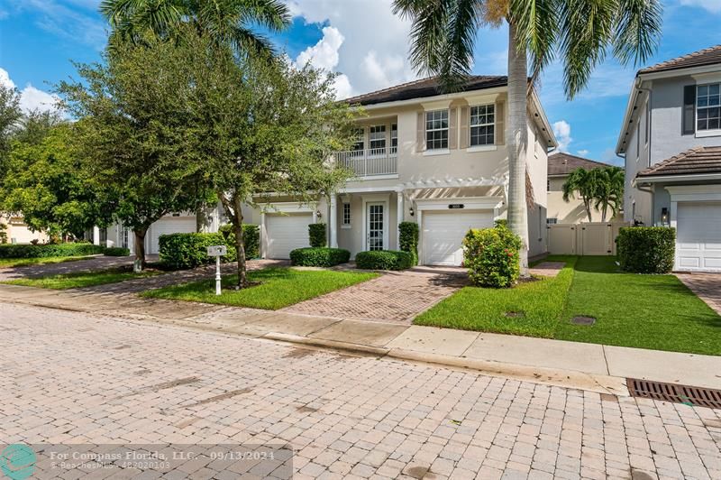 a front view of a house with a yard and a garage