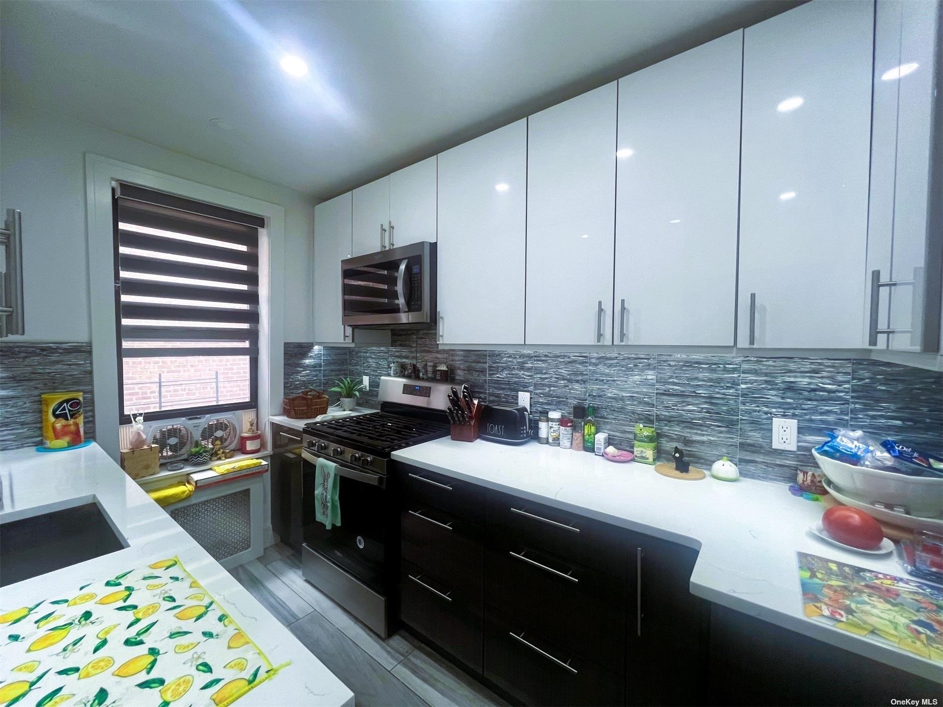 a kitchen with a sink stove and cabinets