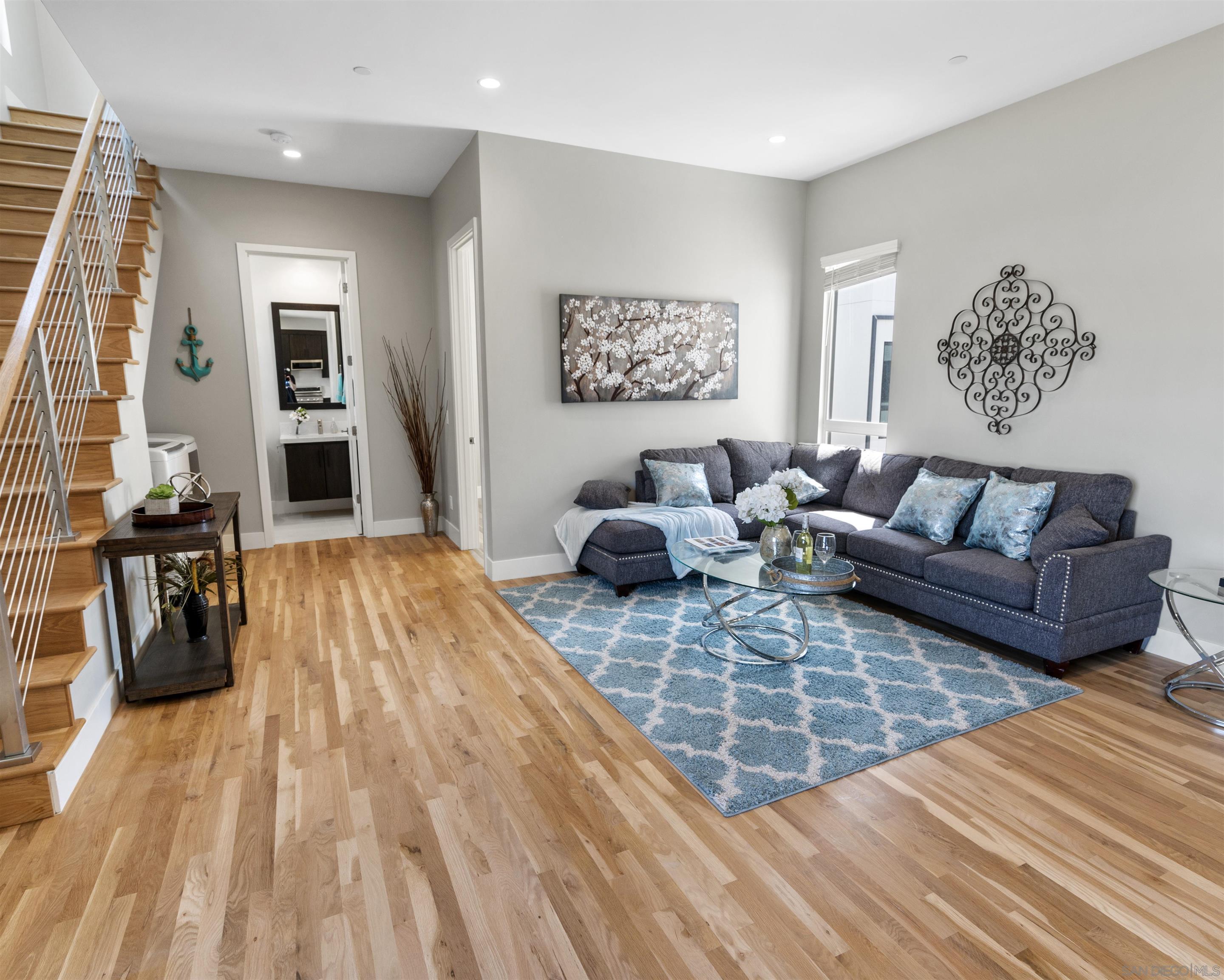 a living room with furniture and wooden floor