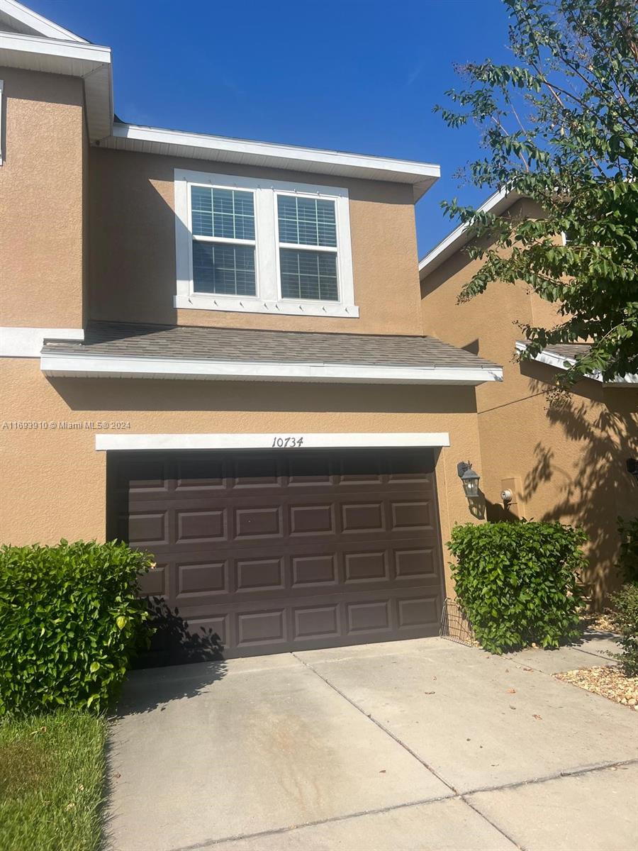 a front view of a house with garage