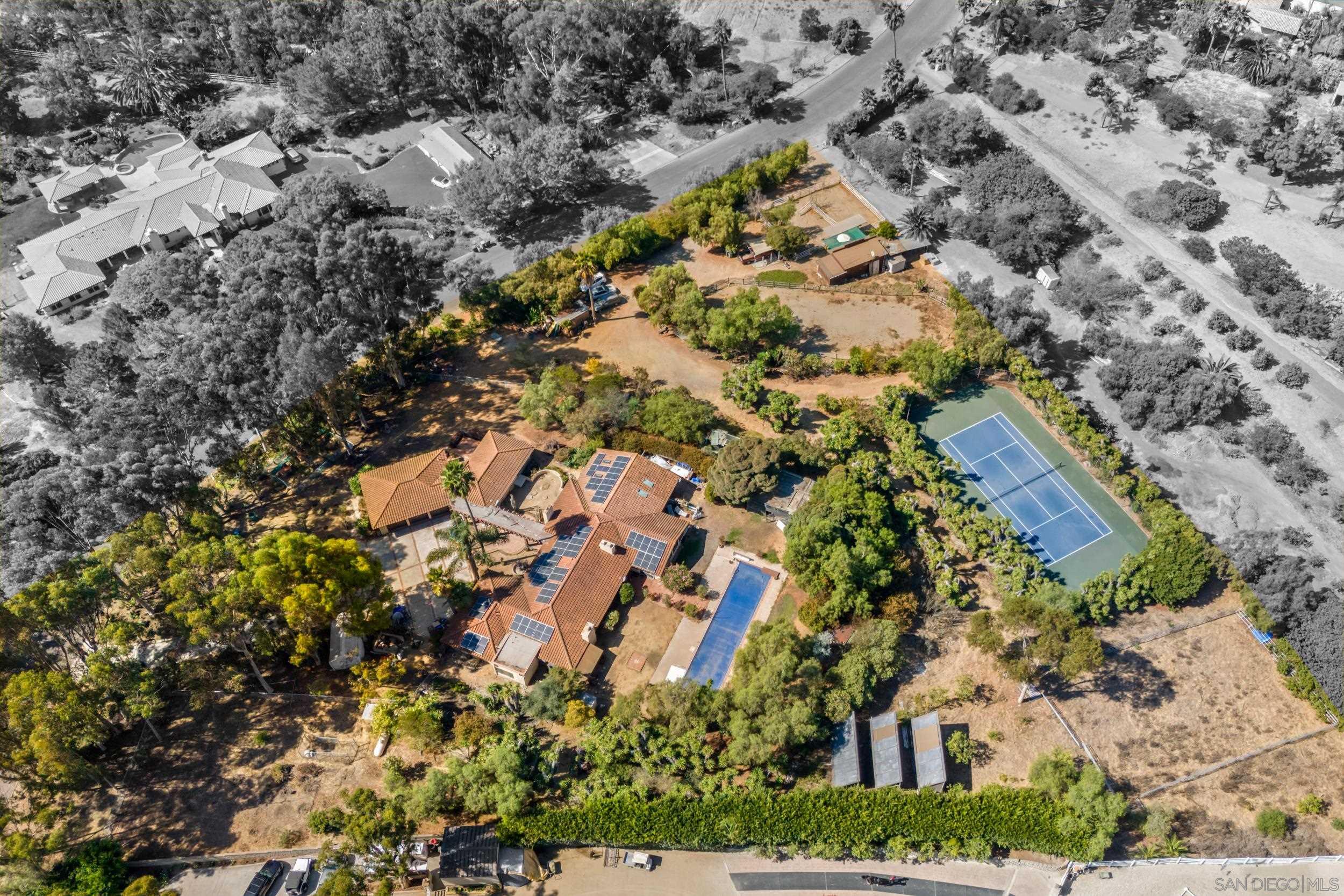 an aerial view of house with yard and mountain view in back