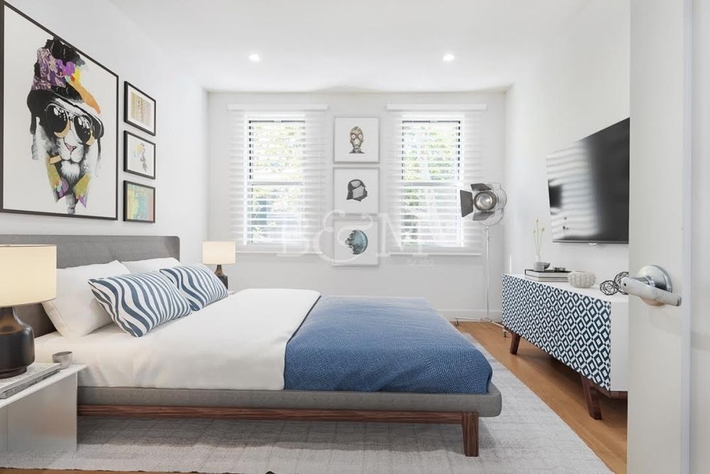 a bedroom with a large bed and a flat screen tv